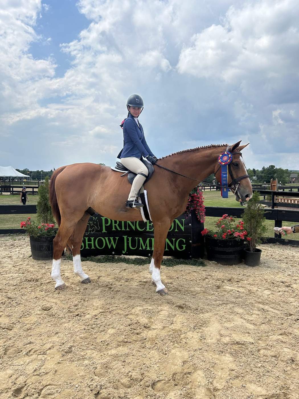 A rider on her chestnut with a championship ribbon at Princeton Show Jumping