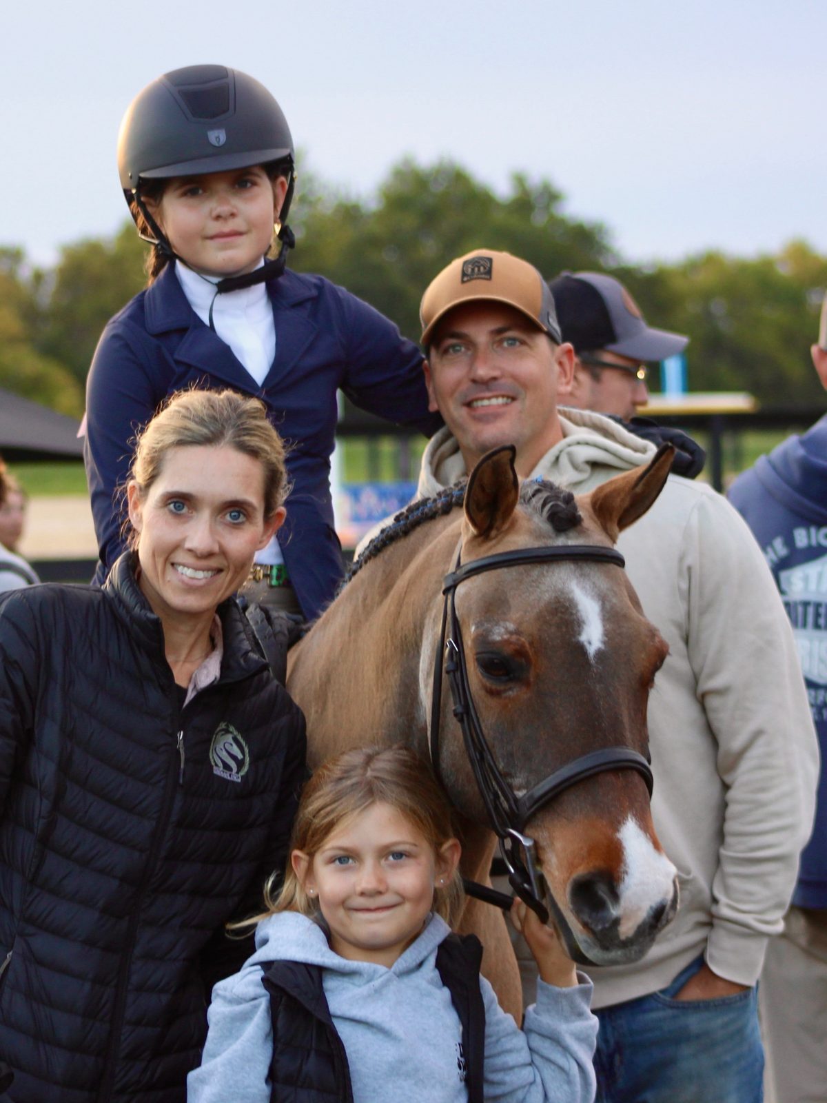 A family with their pony and rider after a class