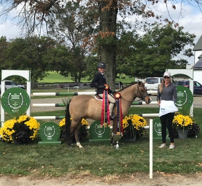 A rider receiving a championship presentation in the ring